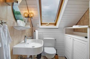 a bathroom with a sink and a toilet and a window at Aussichtsreich Am See in Uhldingen-Mühlhofen +42 photos