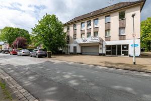 a building with cars parked on the side of a street at Urbanes Nest, ideal für Entdecker in Dinslaken
