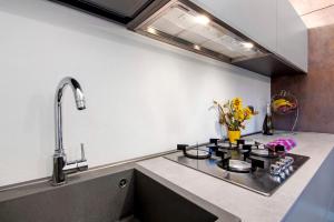 a kitchen with a sink and a counter top at La Sartoria in Porlezza