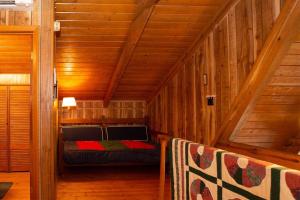 a small room with a bed in a wooden cabin at Chestnut Ridge in Connestee · Chestnut Ridge in Connestee Falls in Rosman