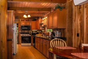 a kitchen with wooden cabinets and a wooden table at Chestnut Ridge in Connestee · Chestnut Ridge in Connestee Falls in Rosman