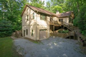 a large house with a porch and a balcony at Pine Hill · Pine Hill in Sherwood Forest in Rosman