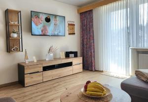 a living room with a tv and a table with bananas on it at Gästehaus Nietmann_ Ferienwohnung 7 in Altenau