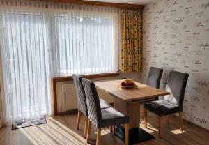 a dining room with a wooden table and chairs at Gästehaus Nietmann_ Ferienwohnung 7 in Altenau