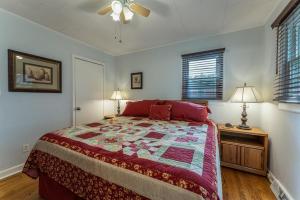 a bedroom with a bed with a quilt on it at Bike Path Getaway in Town · On bike path, NEW KITCHEN,walk to St in Brevard