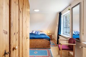 a bedroom with a bed and a mirror at Haus Deichgraf in Nordstrand