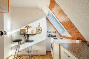 a small kitchen with a counter and a window at Yvette's Ferienwohnung in Lugau