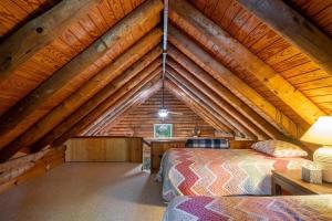 a bedroom in a log cabin with two beds at Great Escape Cabin · Great Escape Cabin in Connestee Falls in Brevard +21 photos