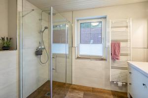 a bathroom with a shower with a glass shower stall at Ferienwohnung Haseltal in Rotenburg an der Fulda +13 photos