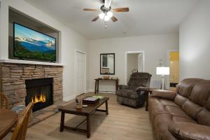 a living room with a couch and a fireplace at Hummingbird Hideaway · Hummingbird Hideaway in Connestee Falls in Brevard