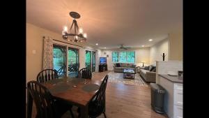a dining room and living room with a table and chairs at Shady Creek Cabin · Shady Creek Cabin in Connestee Falls with s in Brevard