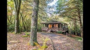 a gazebo in the middle of a forest at Shady Creek Cabin · Shady Creek Cabin in Connestee Falls with s in Brevard