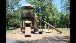 a playground with a slide in a park at Shady Creek Cabin · Shady Creek Cabin in Connestee Falls with s in Brevard