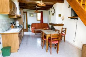 a kitchen and dining room with a table and chairs at Gîte le Suquet - en pleine nature in Dourbies