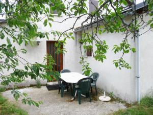 a table and chairs in front of a white building at Gîte le Suquet - en pleine nature in Dourbies +18 photos