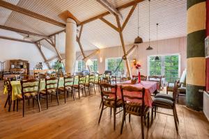 a large dining room with tables and chairs at Haus Deichgraf in Nordstrand