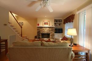 a living room with a couch and a fireplace at White Squirrel`s Nest · White Squirrel`s Nest in Sherwood Forest in Rosman
