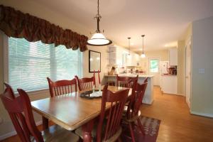a dining room and kitchen with a table and chairs at White Squirrel`s Nest · White Squirrel`s Nest in Sherwood Forest in Rosman