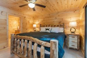 a bedroom with a bed in a log cabin at Hideaway Cabin · Hideaway Cabin in Cedar Mountain in Cedar Mountain