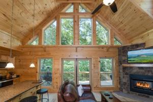 a large living room with a fireplace in a log cabin at Hideaway Cabin · Hideaway Cabin in Cedar Mountain in Cedar Mountain