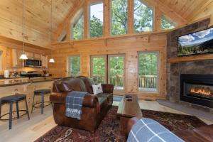a living room with a fireplace in a log cabin at Hideaway Cabin · Hideaway Cabin in Cedar Mountain in Cedar Mountain