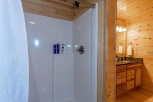 a white shower in a bathroom with a sink at Hideaway Cabin · Hideaway Cabin in Cedar Mountain in Cedar Mountain +15 photos