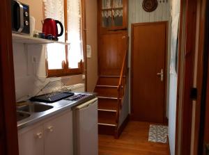 a small kitchen with a sink and a refrigerator at Les Chambres Des Chtis in Abbeville +17 photos