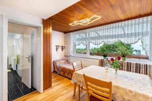 a dining room with a table and a bedroom at Ferienhaus Albert in Bühl