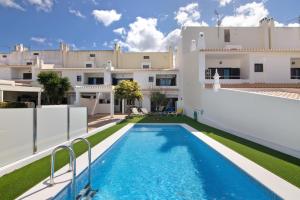 a swimming pool in the backyard of a villa at Villa Neves in Albufeira