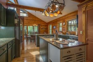 a kitchen with a refrigerator and a counter top at Blissful Bears Mountain · Blissful Bear Cabin, Long Range View 2 in Brevard