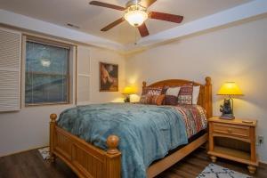 a bedroom with a bed and a ceiling fan at Blissful Bears Mountain · Blissful Bear Cabin, Long Range View 2 in Brevard +25 photos