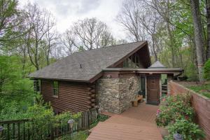 a cabin in the woods with a wooden deck at Blissful Bears Mountain · Blissful Bear Cabin, Long Range View 2 in Brevard