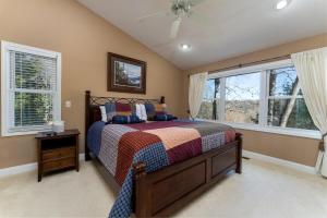 a bedroom with a bed and two windows at Bearly Ruffin It · Bearly Ruffin It in Connestee Falls in Brevard +26 photos