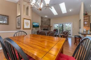 a dining room and living room with a wooden table and chairs at Bearly Ruffin It · Bearly Ruffin It in Connestee Falls in Brevard
