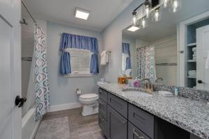 a bathroom with a sink and a toilet and a mirror at Rosie`s Retreat · Rosie`s Retreat in Brevard +16 photos