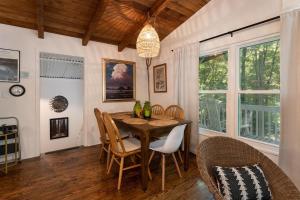 a dining room with a table and chairs at The Deep Forest Green Cottage · The Deep Forest Green Cottage in Cedar Mountain