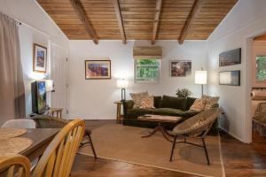 a living room with a couch and a table at The Deep Forest Green Cottage · The Deep Forest Green Cottage in Cedar Mountain