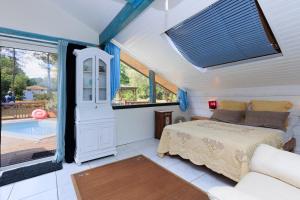 a bedroom with a bed and a large window at Espace, calme, confort in Saint-Michel-Escalus +23 photos