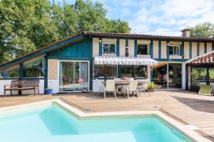 a house with a swimming pool and a patio at Espace, calme, confort in Saint-Michel-Escalus