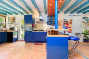 a kitchen with blue cabinets and a blue ceiling at Espace, calme, confort in Saint-Michel-Escalus