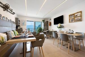 a dining room with a long table and chairs at Eco Del Garda Bnb in Tenno