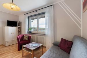 a living room with a couch and a window at Weingut Ringwald in Herbolzheim
