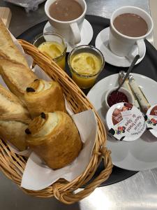 a table with a basket of bread and cups of coffee at La Baïta De La Foux in La Foux d'Allos +17 photos