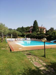 a large swimming pool with chairs in a yard at Palazzetto Bovini in Perugia