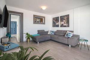 a living room with a couch and a table at Villa Esmeralda in Lanzarote