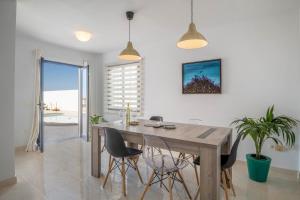 a dining room with a wooden table and chairs at Villa Esmeralda in Lanzarote