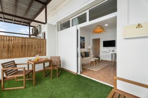 a room with a table and chairs and a living room at La Atalaya in Adeje