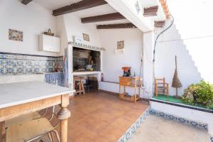 a kitchen with a counter and a table in a room at Ca La Morancica in Yátova