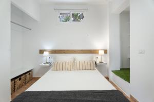 a bedroom with a large white bed with a window at La Atalaya in Adeje +138 photos