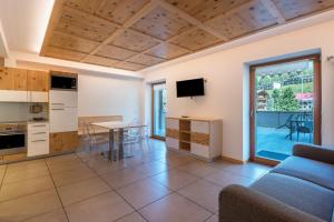 a living room with a couch and a table at Buffaure a parte in Pozza di Fassa